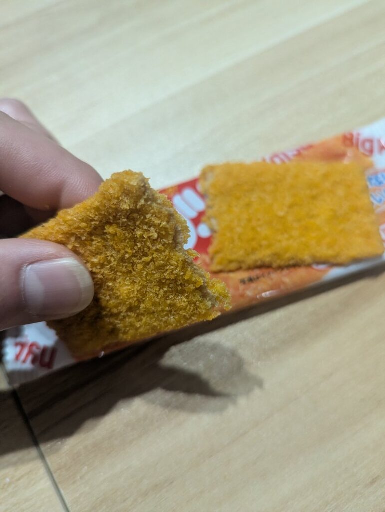 Big Katsu Japanese snack being broken in half