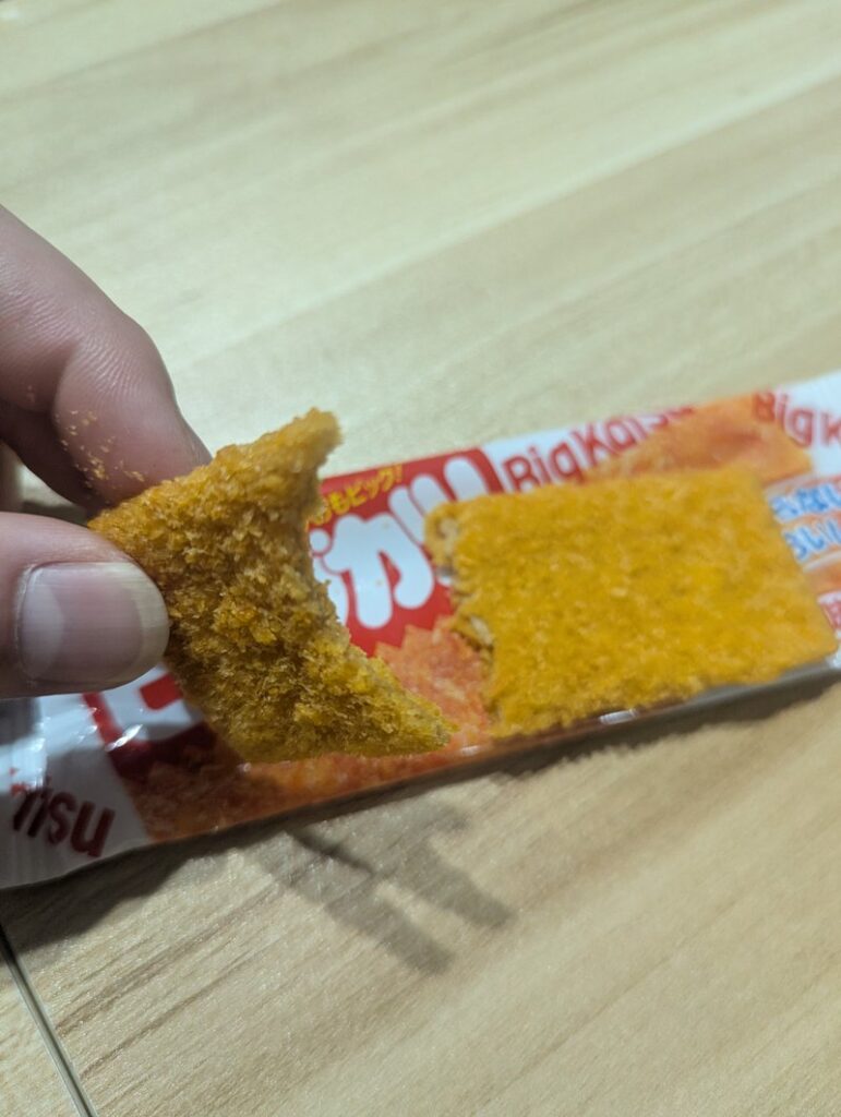 Eating Big Katsu Japanese fish cutlet snack by hand