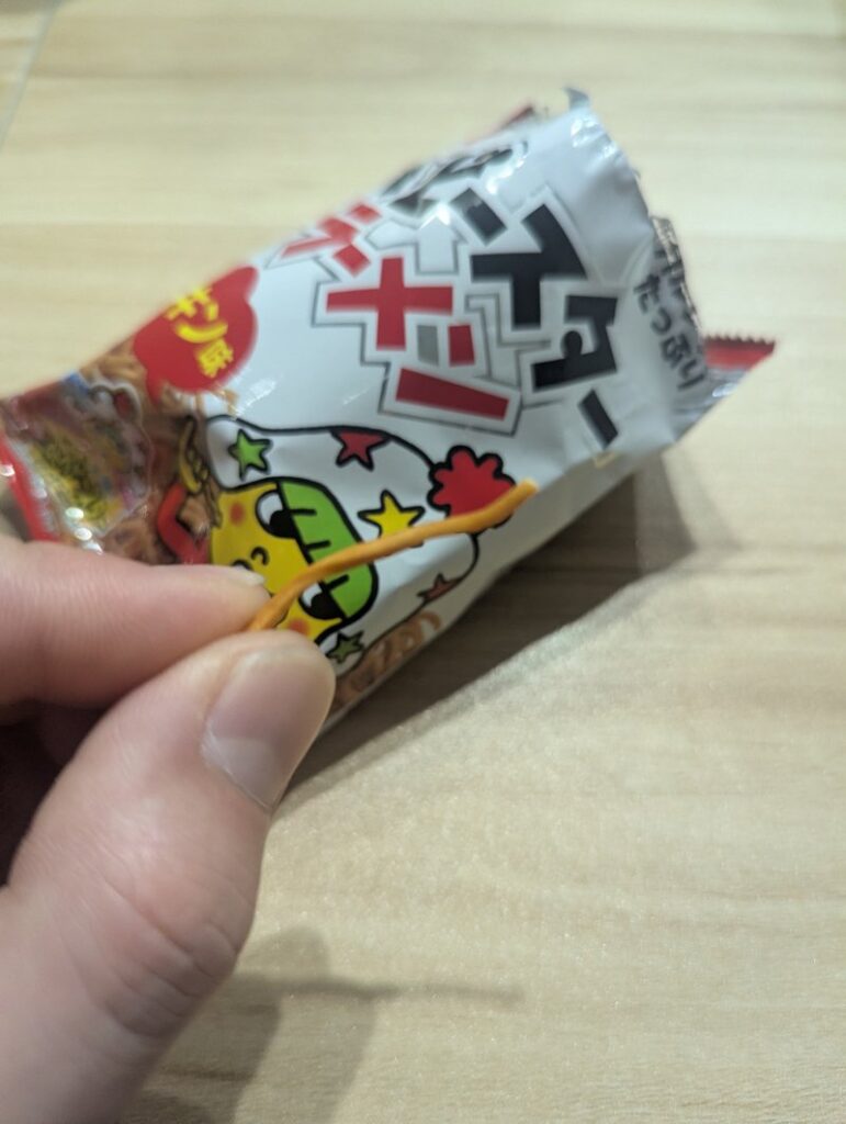 Baby Star Ramen Mini bag held in hand showing compact size