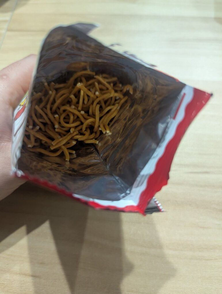 Inside view of open Baby Star Ramen bag showing the crispy noodle pieces