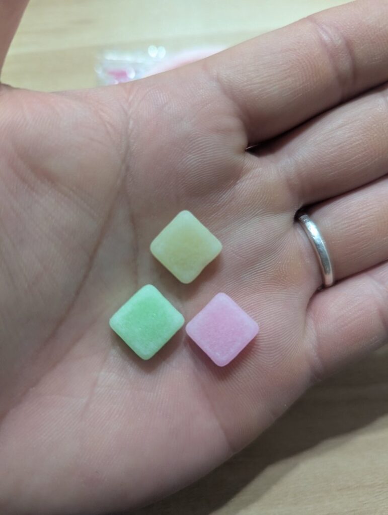 Fruits no Mori colorful fruit candies pink green yellow close-up on hand