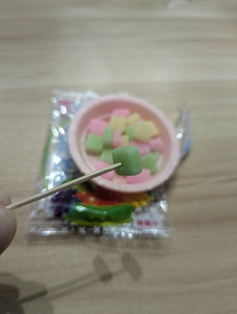 Skewering Fruits no Mori candy with toothpick Japanese dagashi