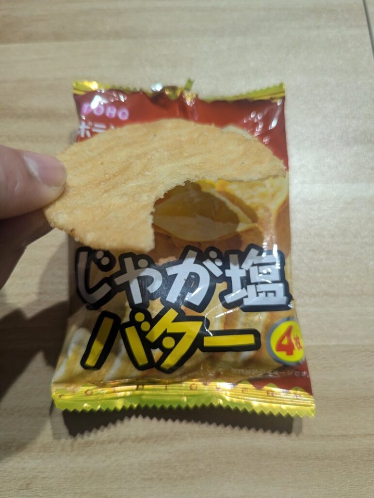 Eating Potato Fry Jaga-Shio Butter Japanese snack by hand