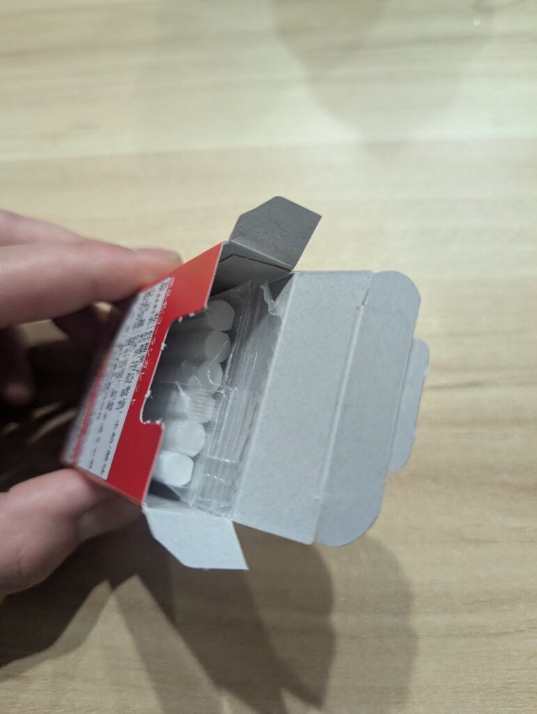 Inside view of opened Cola Cigarette box showing ramune candy sticks