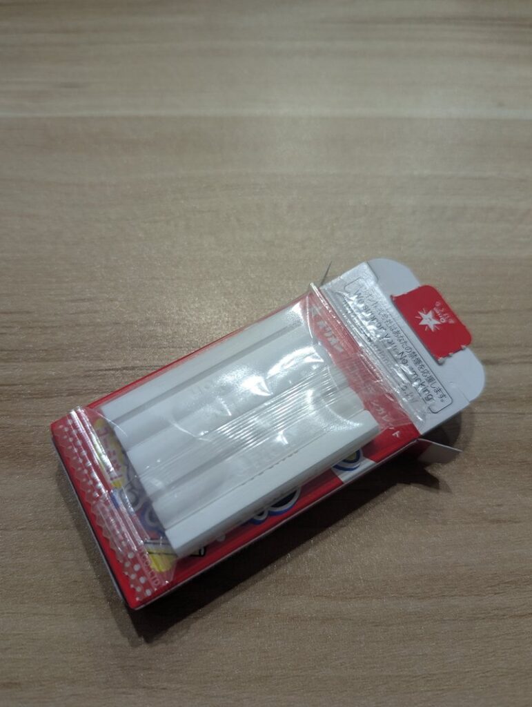 Six Cola Cigarette ramune candy sticks laid out showing cigarette-like shape
