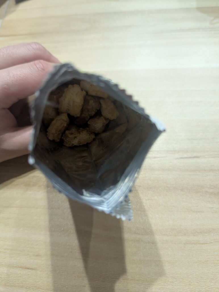 Top view of opened Dondon Yaki bag showing crispy snack pieces inside