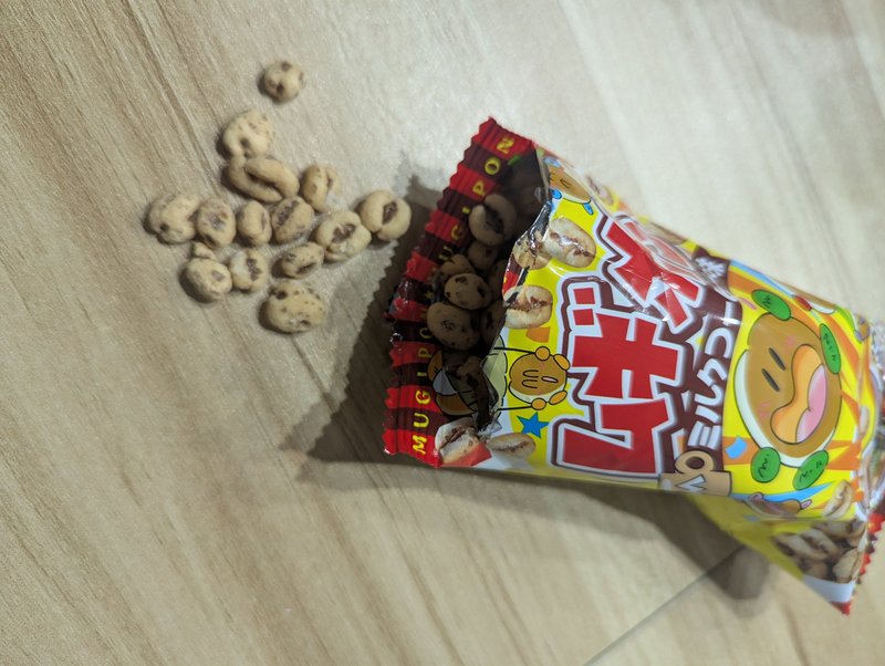 Mugipon milk coffee puffed wheat pieces spilling out of the open bag
