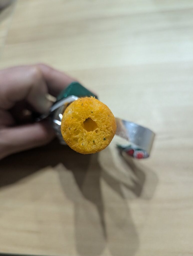 Cross-section of Umaibo Yasai Salad showing hollow center of the corn puff