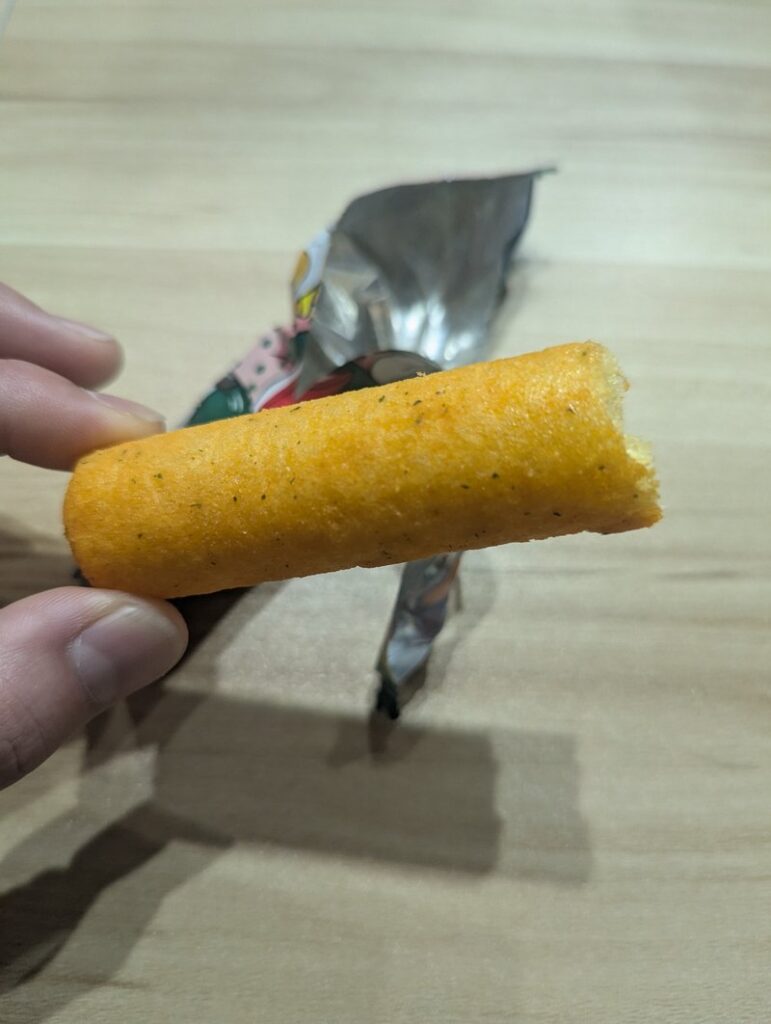 Close-up cross-section of Umaibo corn puff showing light airy texture