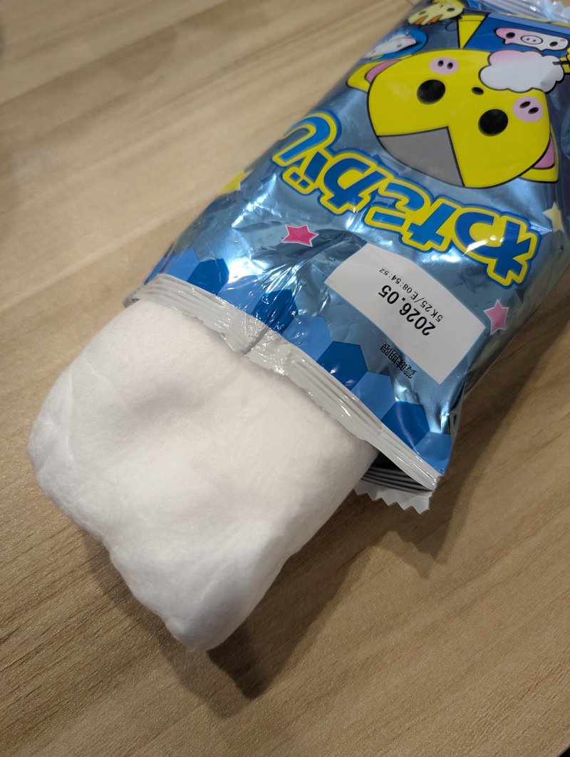 Watagashi cotton candy spilling out of the opened bag from the side