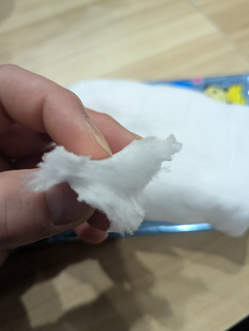 Pulling a piece of watagashi cotton candy from the bag